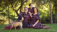 A family of three in Ivy City Co. plaid Madeline outfits in navy.
