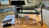 The Typhur Sous Vide Station on wooden countertop inside of kitchen.