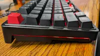 Side view of the Keychron C3 Pro gaming keyboard with black keys and red ESC key.