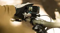 Photo of a model holding a GoPro Hero action camera.