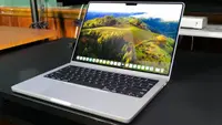 The MacBook Pro 14 M3 on a black table.