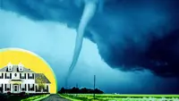A white-colored home in front of a yellow, circular background opposite a large tornado