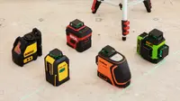 Five laser levels sit on a light color floor