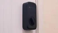 The Abode Lock mounted on white door.
