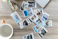 Several digital photos that were printed sitting on a coffee table.