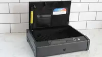 The Lockly Smart Safe with the lid open on a marble counter.