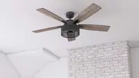 A Honeywell ceiling fan hangs from a white ceiling.