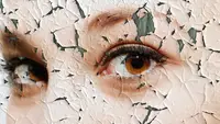 Close up person's face with the paint chipping away like dry, flakey skin