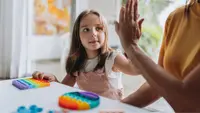 Child giving a high-five to a adult