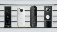 Four video doorbells sit on a house clapboard