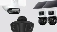 Three large sized security cameras on a gray background