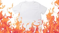 A white t-shirt on a white background has flames leaping over it
