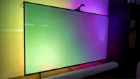 Govee TV Backlight 3 shown behind a TV displaying yellow, green, and purple lighting.