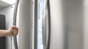 A refrigerator door held open to show the gasket.