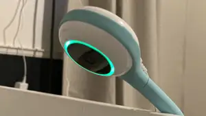 Lollipop Smart Baby Camera in blue and white color angled downwards over baby crib.