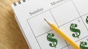 A calendar on a desk labeled with dollar signs on each day
