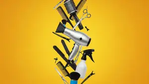 Hair styling tools and accessories against a yellow background