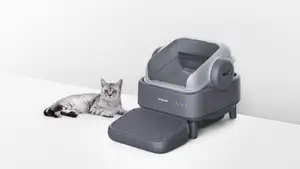 A cat lays beside the OneIsAll litter box