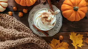 Pumpkins, leaves, a coffee cup, and a blanket