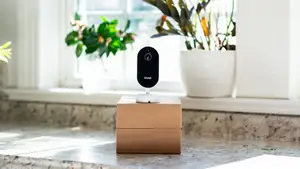 Owlet Dream Sight camera sitting on a brown box in front of a window.
