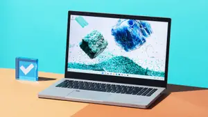 The Acer Aspire Vero (2022) on a desktop with a baby blue background.