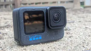 The GoPro Hero12 Black laying on the ground in an outdoor setting.