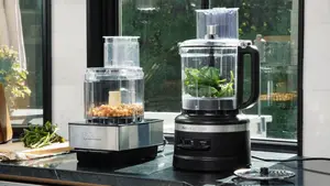 Cuisinart Food Processor sit next to each other on a black countertop