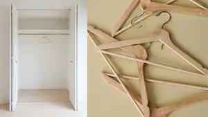An empty closet next to a pile of empty hangers