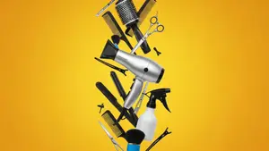 Hair styling tools and accessories against a yellow background