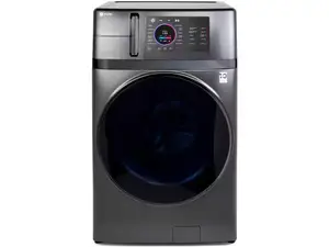 An LG washer-dryer combo in the Reviewed testing lab in front of a wall of copper pipes.