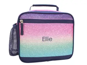 Eight colorful lunch coolers from brands like L.L. Bean, PackIt, Pottery Barn Kids, and Coleman sit on a kitchen counter.