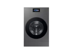 An LG washer-dryer combo in the Reviewed testing lab in front of a wall of copper pipes.