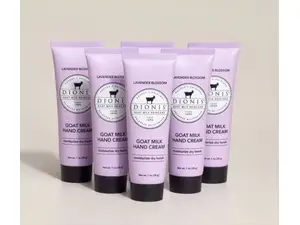 Five hand cream tubes in a collage against a blue and green background.