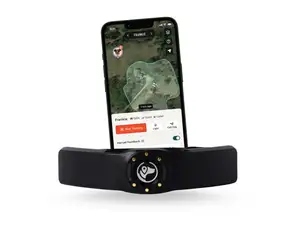 Light grey Australian Shepherd standing on green grass with the SpotOn GPS collar on his neck.