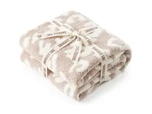 Three throw blankets placed on a couch