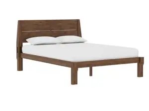 An orange pillow sits on the end of a bed near a wooden bedframe