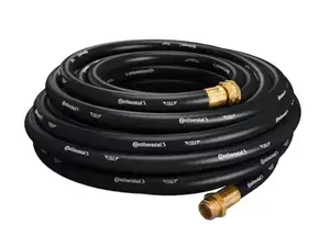 A person watering the grass with a garden hose