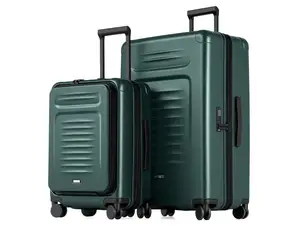 Woman with a white top and light green pants walking on cobblestone with the Coolife Luggage Set Checked Suitcases.