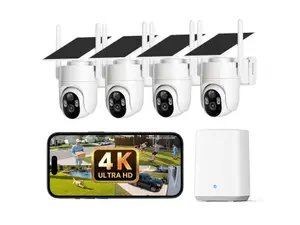 White Elysoo 4K Wifi Solar Camera mounted on a grey house with trees in the background.