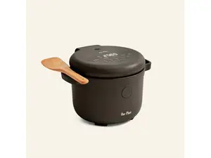 Our Place Rice Cooker in Spice with 47 minutes on timer and beechwood paddle resting on handles