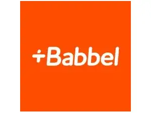 A laptop sits on a table showing Babbel's dashboard