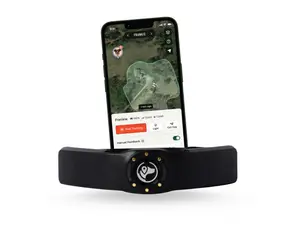 SpotOn GPS Dog Fence (Nova Edition) in black shown on a grey counter in front of a white wall and two windows.