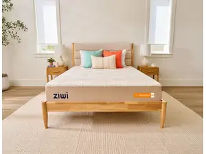 a woman lies down on a stack of mattresses reading