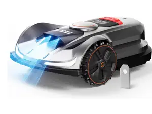 Silver Sunseeker Elite X7 robot lawn mower on grass in front of some bushes.