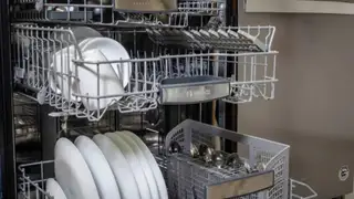 A Bosch dishwasher with its middle and upper racks open.