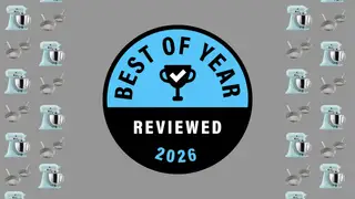 Reviewed's Best of Year Award badge on a gray background with pans and stand mixers