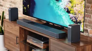The JBL Bar 1300X on a TV console.