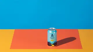 A gif of cans and bottles of nonalcoholic beer appearing on a colorful surface