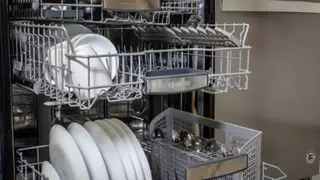 A Bosch dishwasher with its middle and upper racks open.