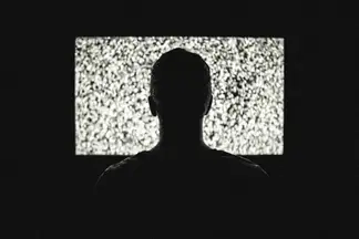 Guy watching fuzzy TV